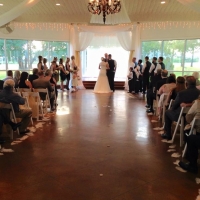 vows in August with aisle lined with feathers
