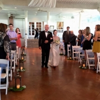 walking the aisle in oct aligned with elegant lanterns