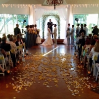 yellow and white rose petals, yellow sashes, and saying I do