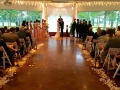 Saying I do at a wedding at House  Estate with rose petals and lantern aisle markers