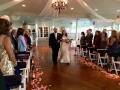walking the aisle aligned with rose petals and lanterns in October at House  Estate