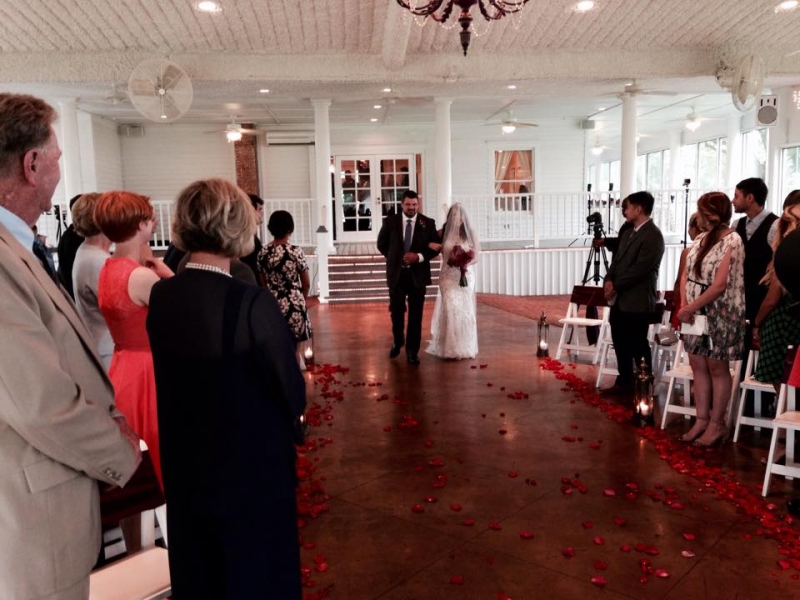 walking down the aisle at House  Estate adorned with red rose petals