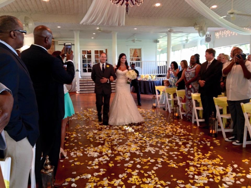 walking the aisle with white and yellow rose petals