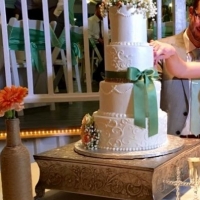 elegant four tiered cake with green ribbon