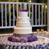 perfect four tiered wedding cake with purple flowers