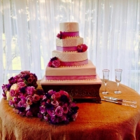 sleek wedding cake with beautiful purple and pink flowers
