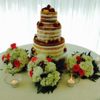 wedding dessert cake with fruit, flowers and candles