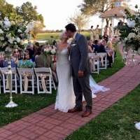 A kiss after sharing their vows at an outdoor wedding at House  Estate
