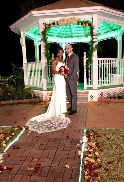 outdoor wedding with a lit up gazebo at night in december