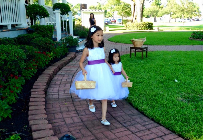 precious flower girls and their baskets full of flowers