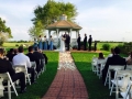 Outdoor gazebo wedding aligned with white rose petals at House  Estate