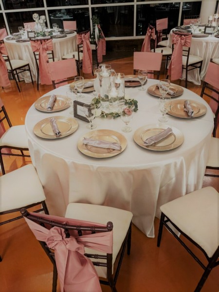 Cylinder-candle-centerpieces-with-ivory-tablecloths-at-House-Estate