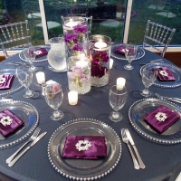 reception tables with water filled flower centerpieces