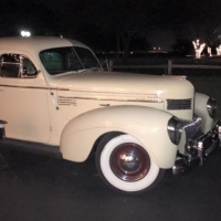 Antique cars and tree lit drive at House  Estate