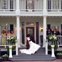a dip at the front steps with the wedding party and bride and groom.JPG