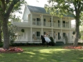 beautiful victorian mansion with horse and bride