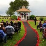 breathtaking outdoor wedding with red rose petals at House Plantation